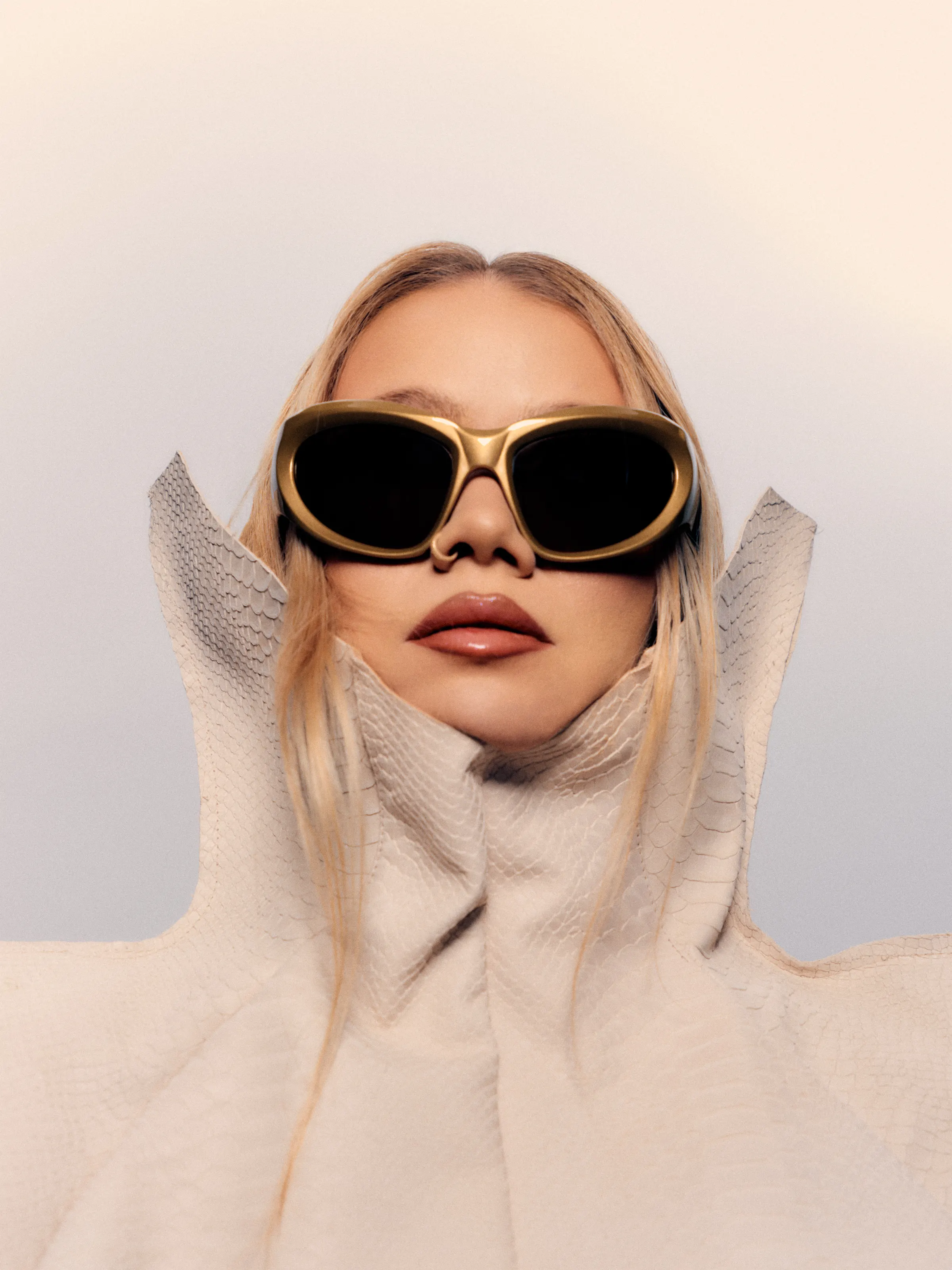 Close-up of Simona Mereu wearing oversized gold sunglasses