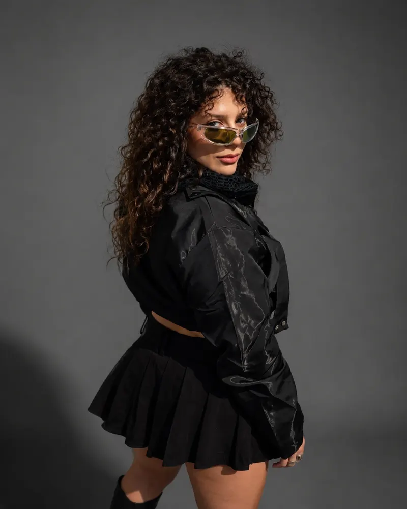 Sara, the December Twerk group's teacher, in black, wearing sunglasses
